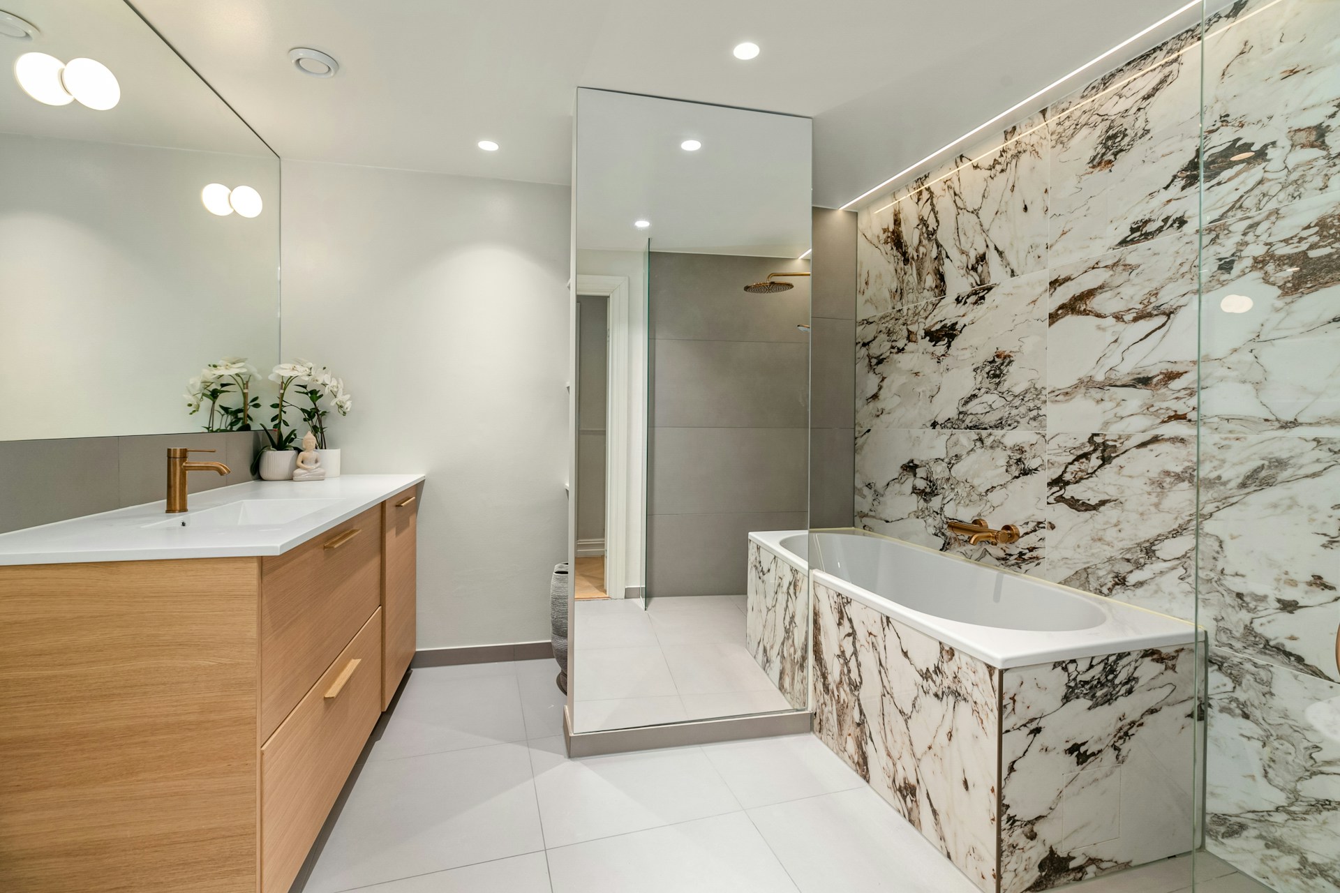 large bathroom with floor to ceiling mirror and glass in shower enclosure