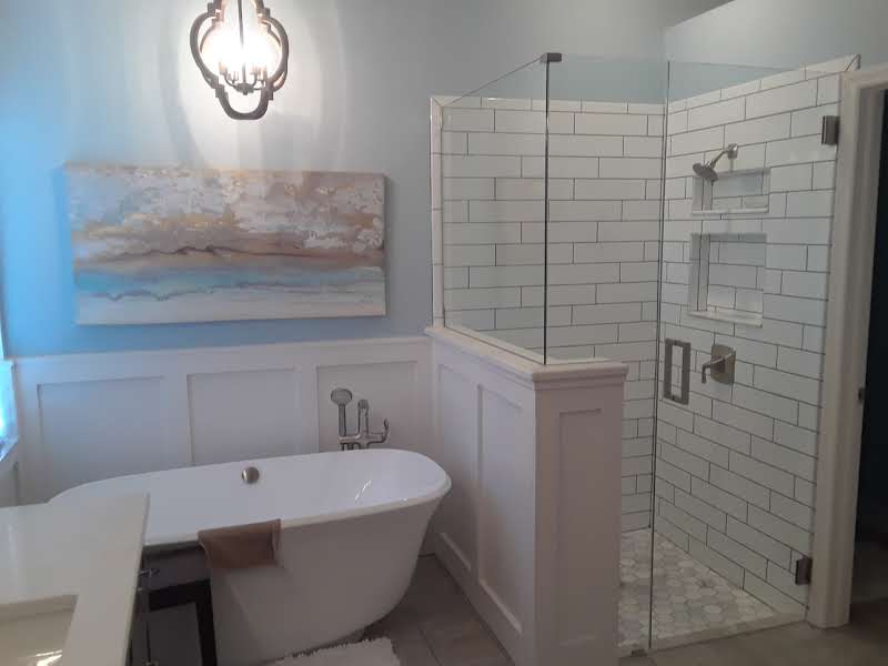 custom glass shower enclosure with tub next to it